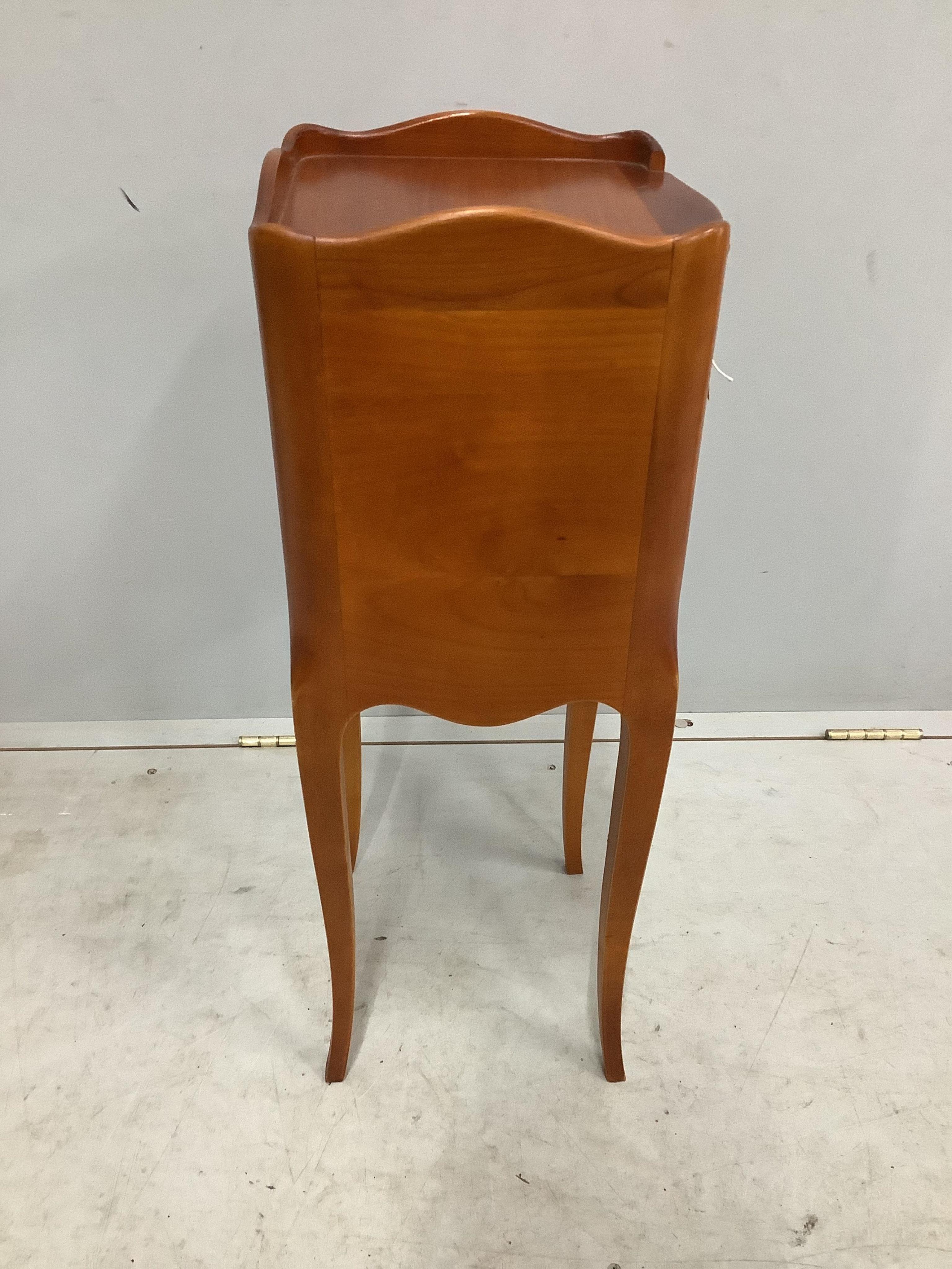 A pair of French cherry three drawer bedside chests, width 24cm, depth 26cm, height 70cm. Condition - fair to good